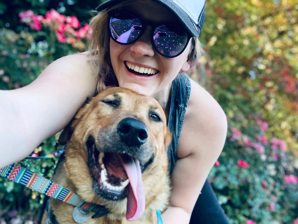 Pet parent holding her dog while planning for the dog's future care
